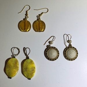 3 pairs of pendant style costume jewelry earrings.